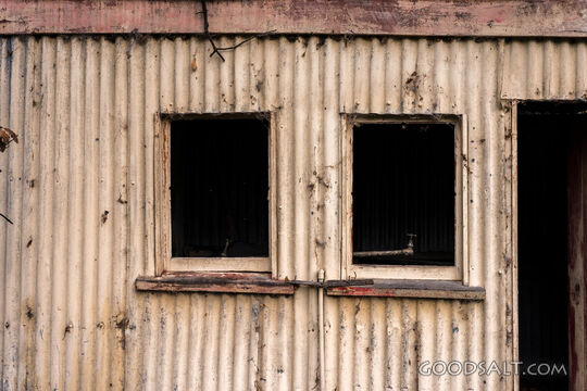 close-up of decayed windows on old shed