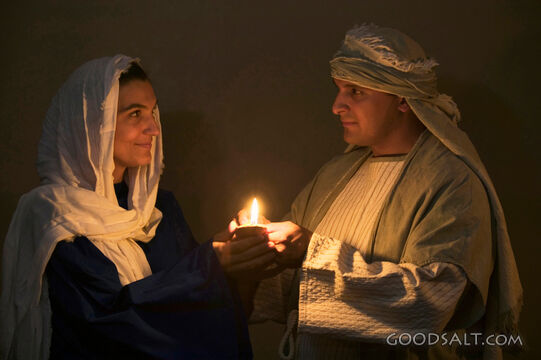 Isrealite Man and Woman Hold Lit Oil Lamp in the Dark